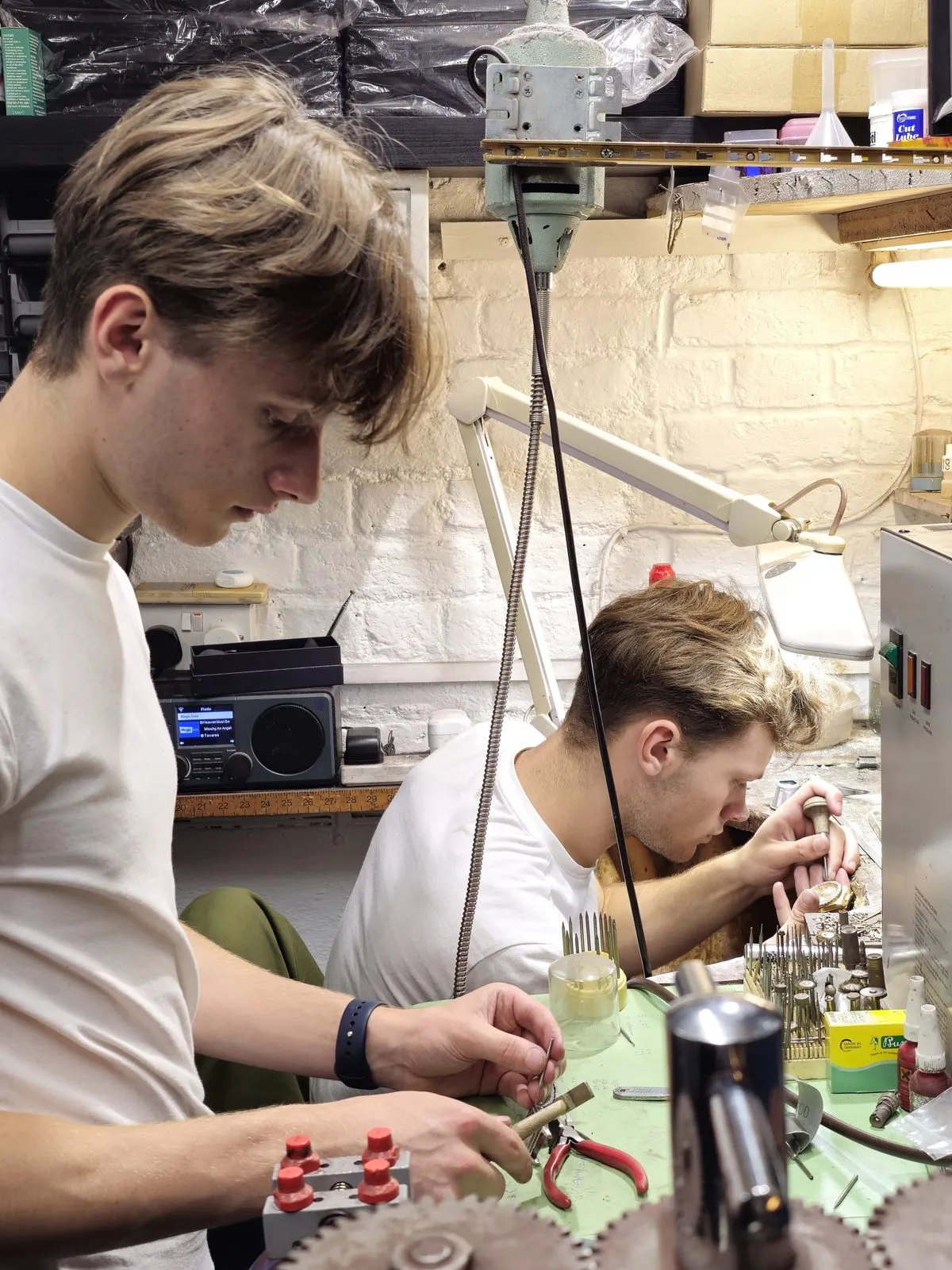 William and Oliver working side by side at the jewellery bench